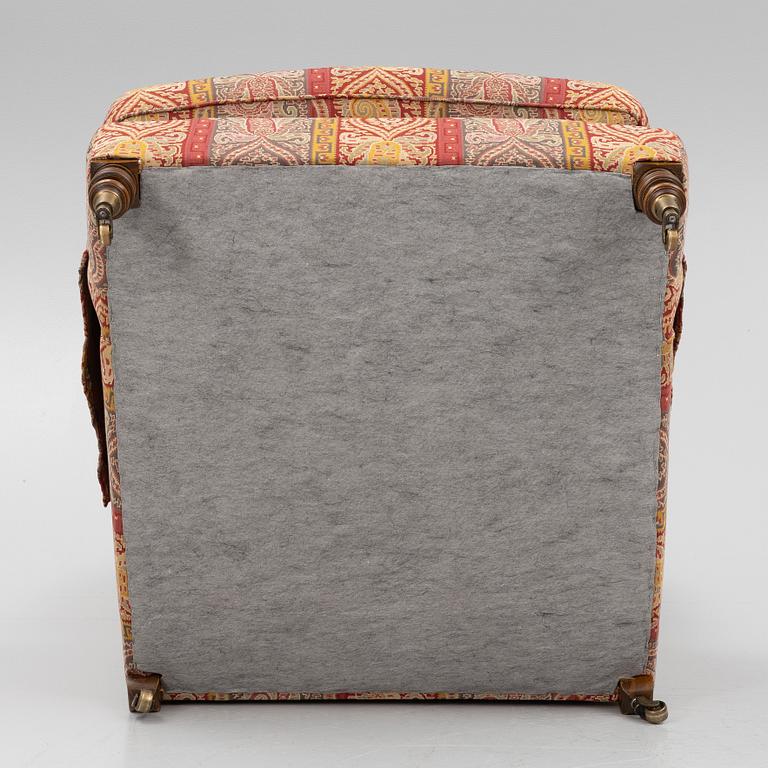 A Howard armchair with ottoman.