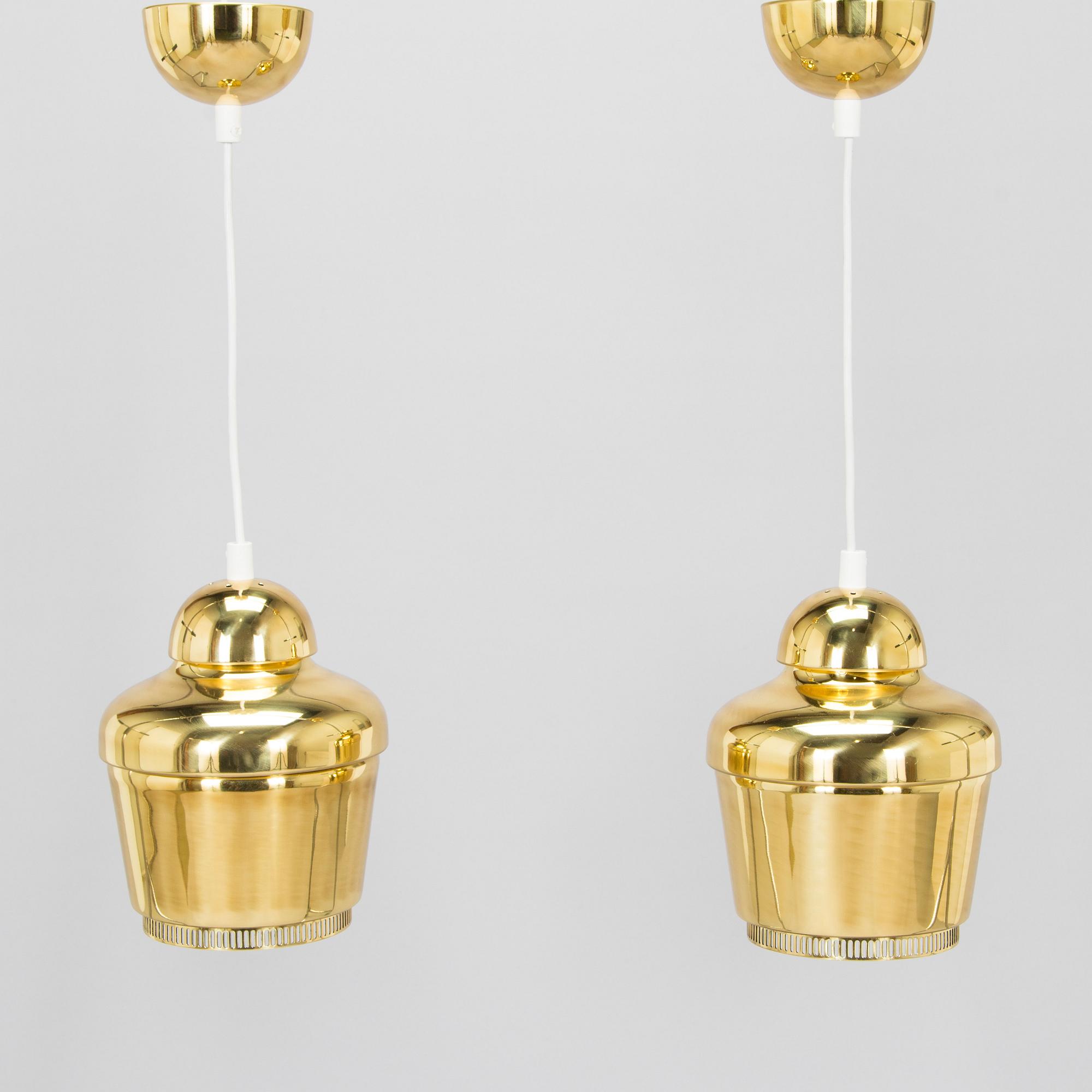 Alvar Aalto, A pair of  A 330, 'Golden Bell' pendant lights A330 for Artek, 2000s.