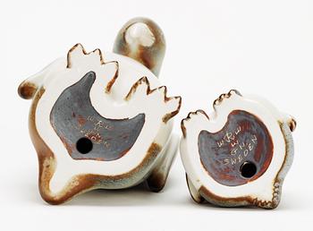 Two Gunnar Nylund stoneware figures depicting a penguin mother and child, Rörstrand.