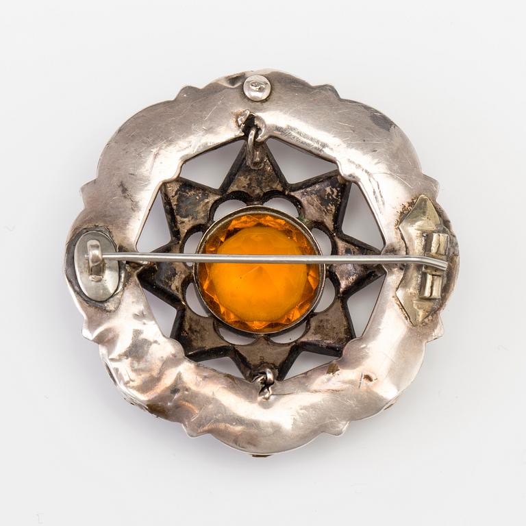A BROOCH set with amber-coloured paste, heliotrope and jasper.