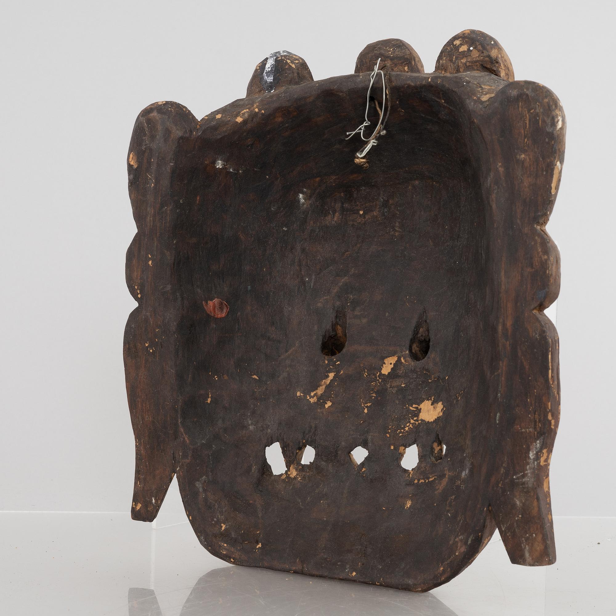 Four Tibetan/South East Asian wooden decorations, 20th century.