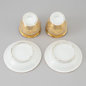 a pair of late empire porcelain cups with saucers from the first half of the 19th century.