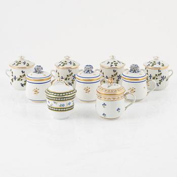 A set of nine Austrian and French custard cups with covers, 19th/20th Century.