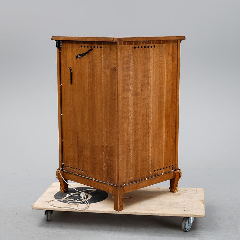 A 20th century Rococo style corner cabinet.