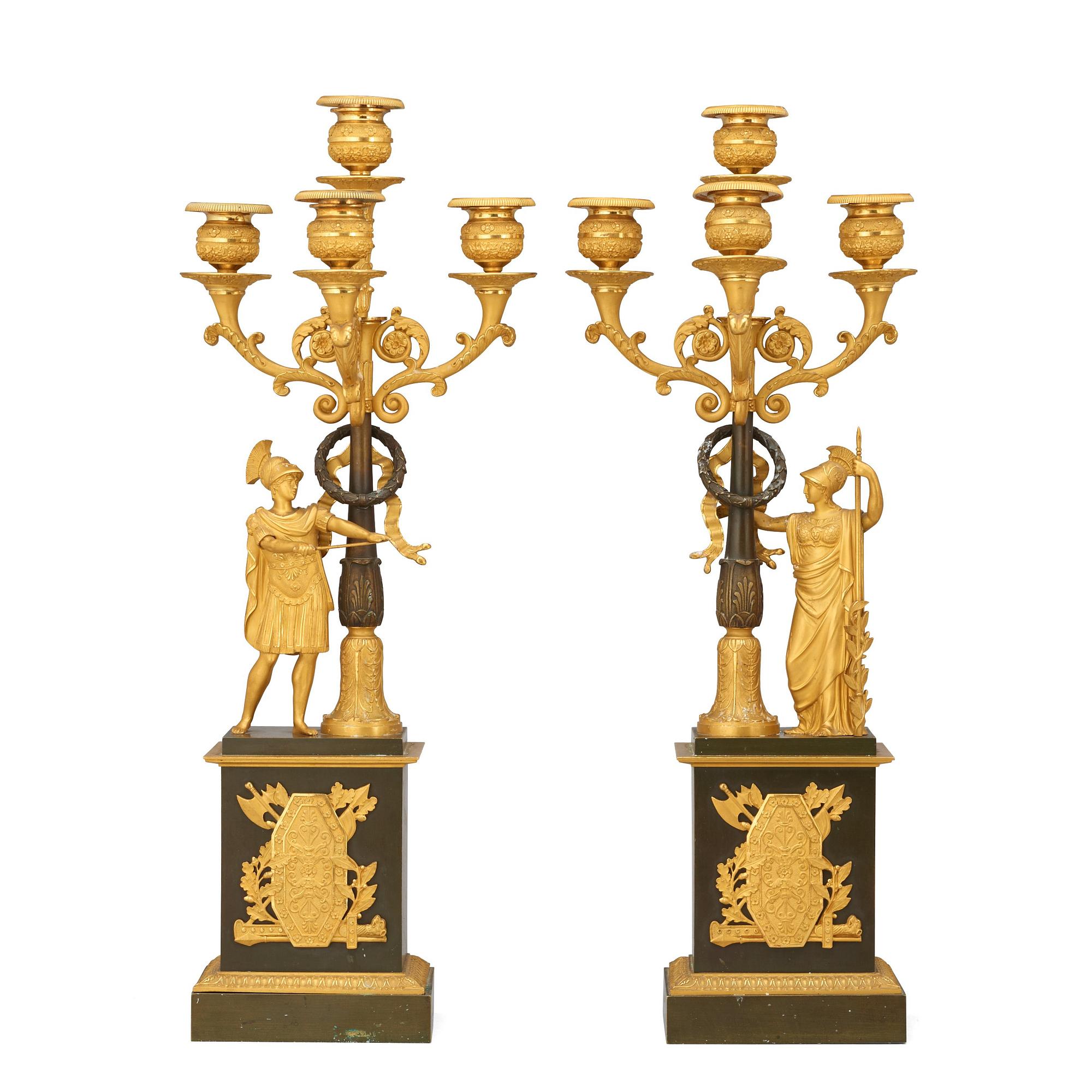 A pair of French Empire early 19th century gilt and patinated bronze four-light candelabra.
