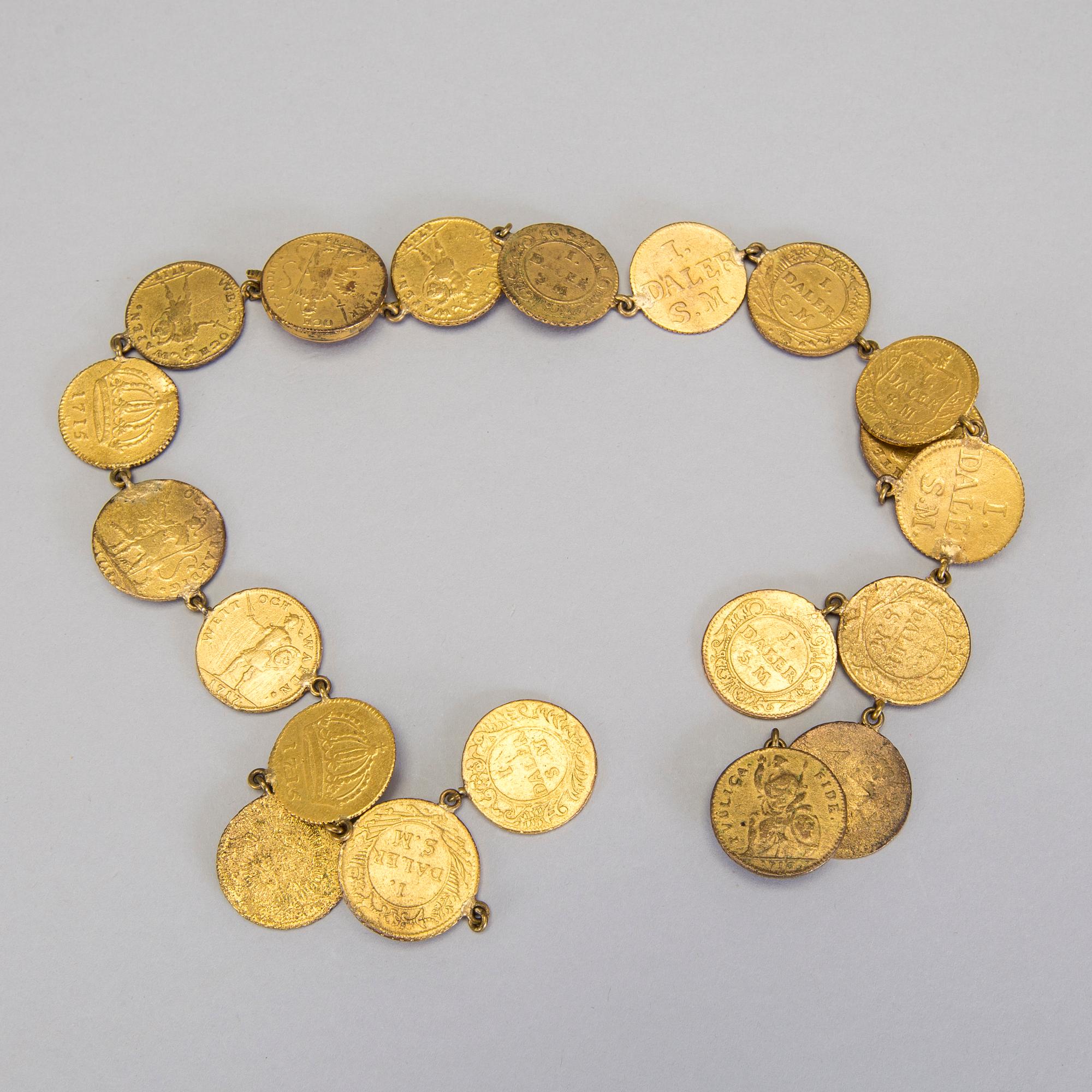 A collection of mostly silver, tradition folk buttons and belt buckles.