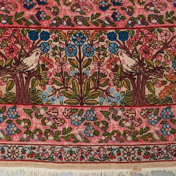 A CARPET, a semi-antique Kerman, ca 479 x 317 cm.