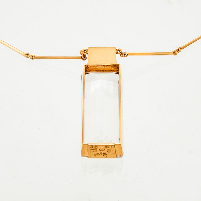 An 18K gold necklace set with a step cut rock crystal quartz by Ateljé Stigbert 1943.