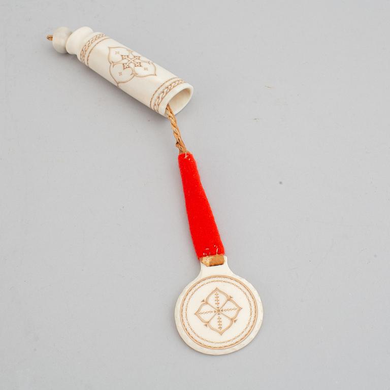 Four Sami pendants, reindeer horn, birch and embroidery with silver thread, one signed TF for Torsten Fankki.