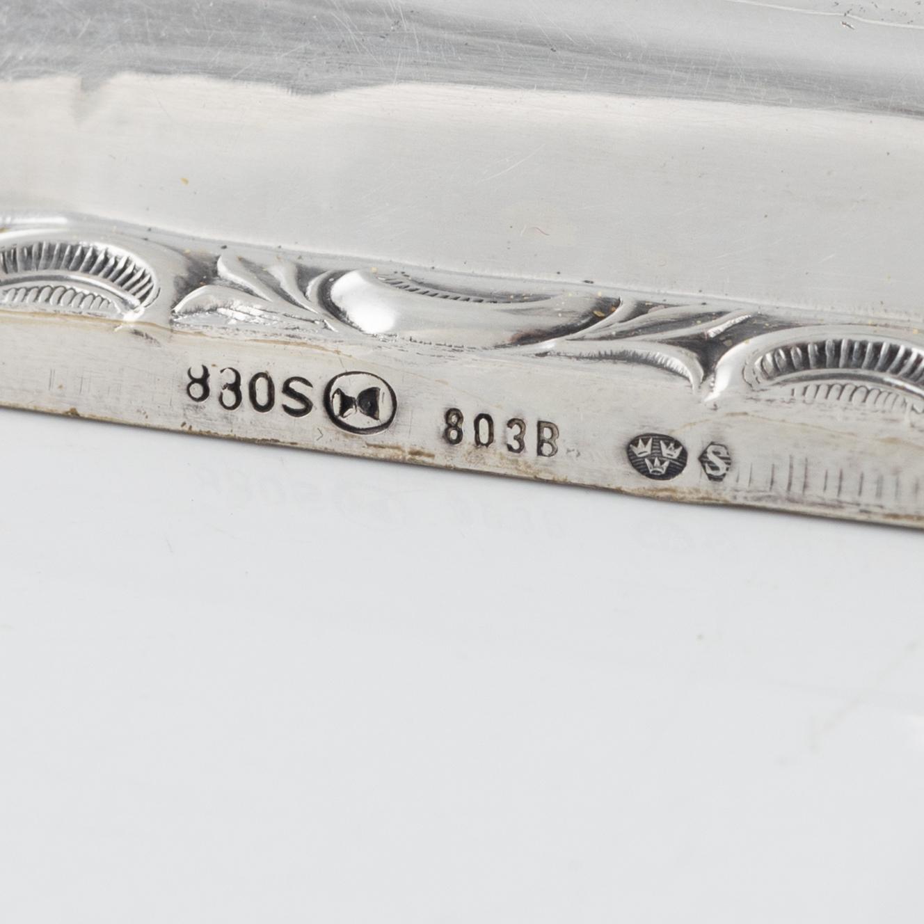 A Swedish Silver Ladle, mark of Adolf Öström, Piteå 1887 and a pair of Silver Candlesticks.