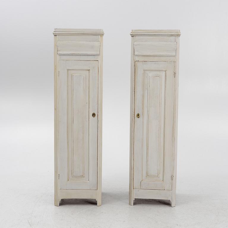 A pair of painted cabinets with a drawer.