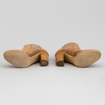 A pair of suede bootie byRalph Lauren.