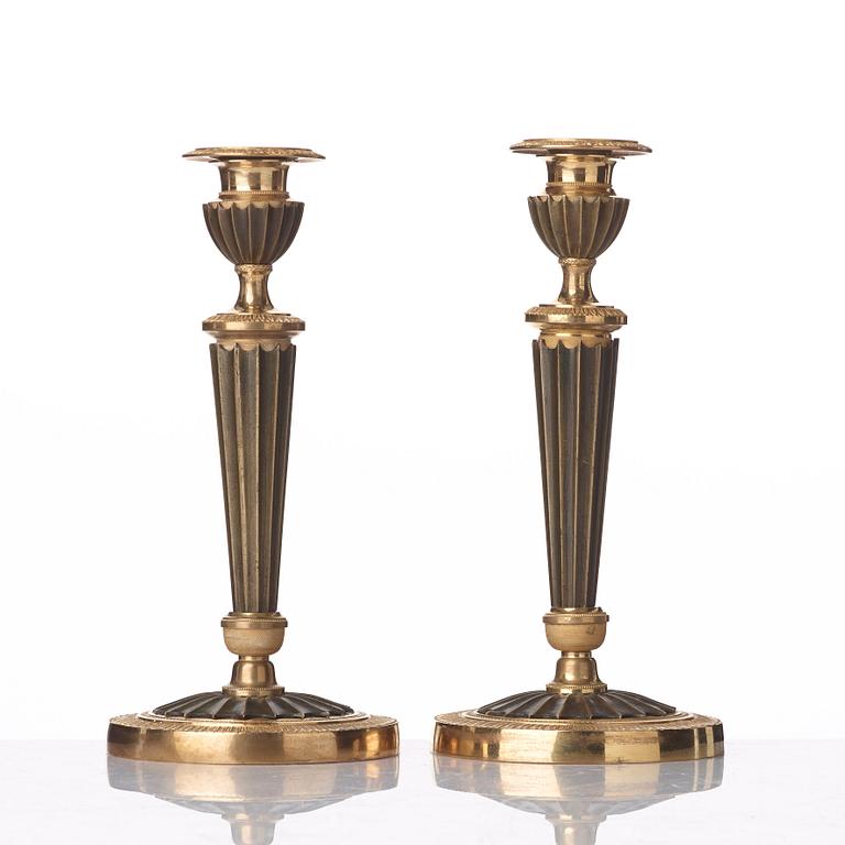 A pair of French Empire early 19th century candlesticks.