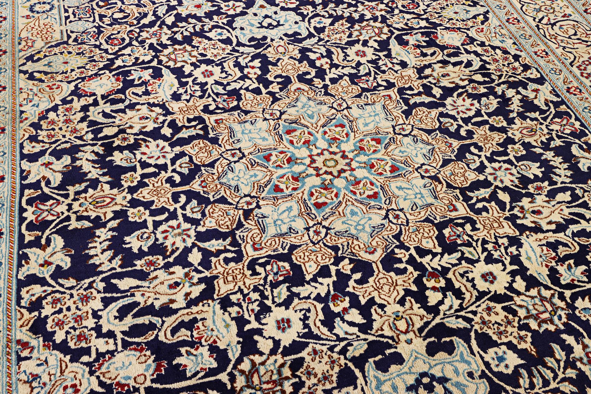 A Nain carpet, part silk, c. 338 x 244 cm.
