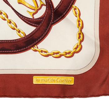 Three Cartier silk scarves.