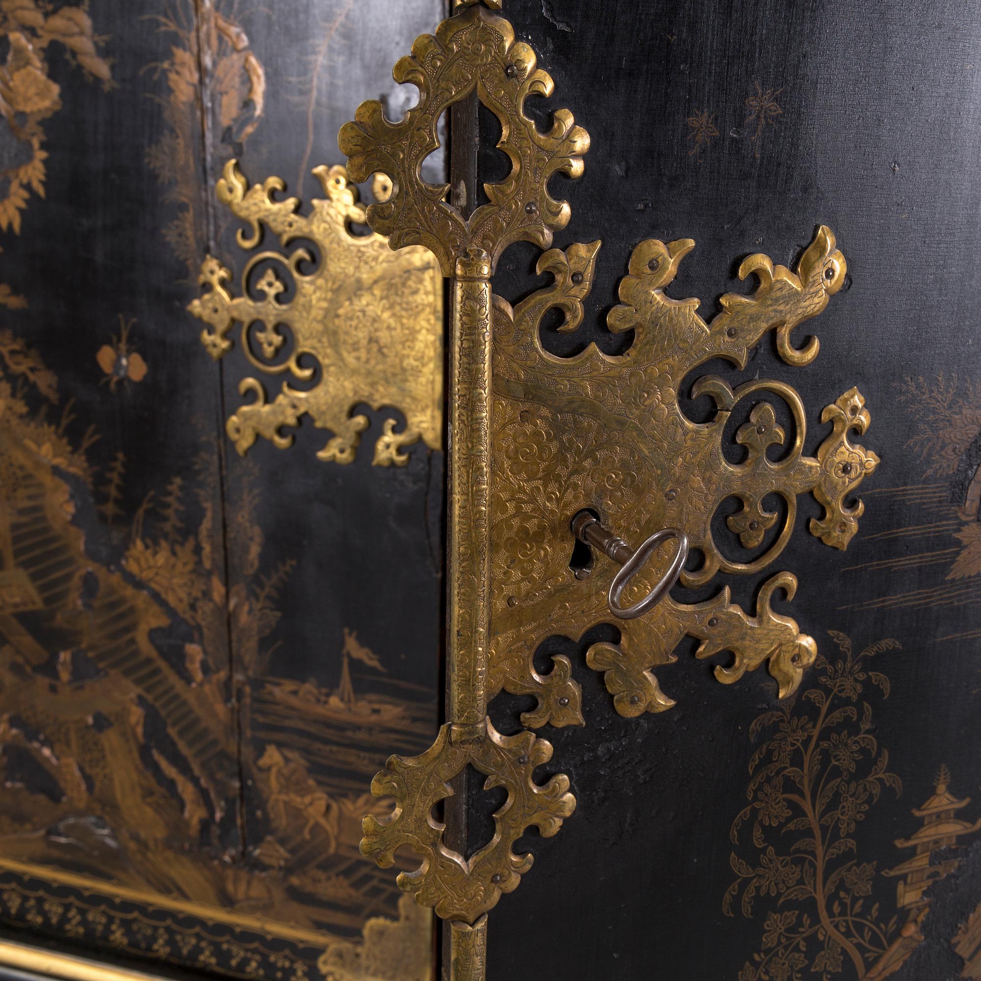 AN early 18TH CENTURY PROBABLY ENGLISH Japanned laquer cabinet on stand.