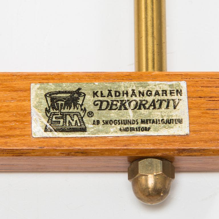 Two mid 20th century brass and teak coat hanger "Dekorativ" from Skoglunds metallgjuteri, Anderstorp.