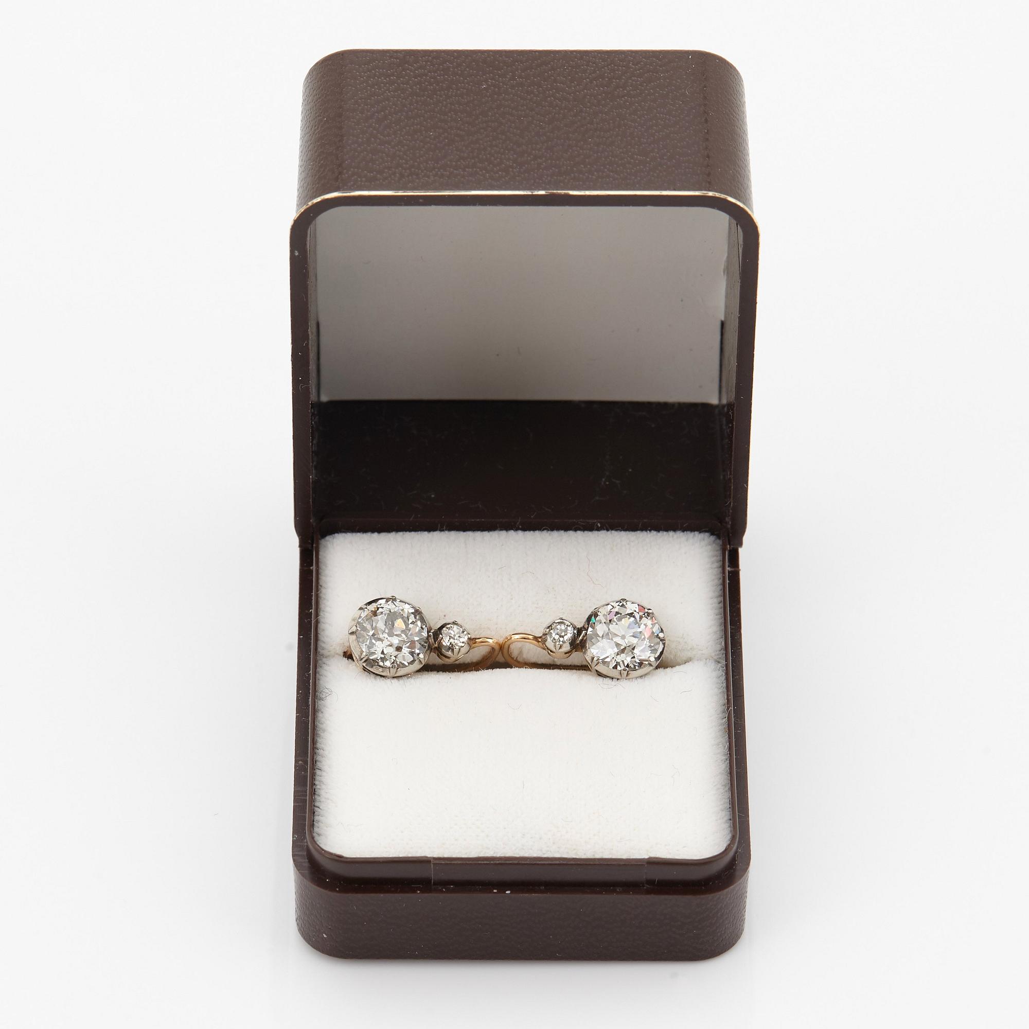 A pair of 14K gold earrings set with old-cut diamonds with a total weight of ca 2.50 cts.
