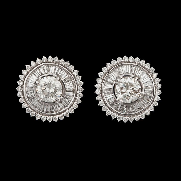 A pair of  brilliant- and tapered baguette-cut diamond earrings. Total carat weight circa 4.05 cts.
