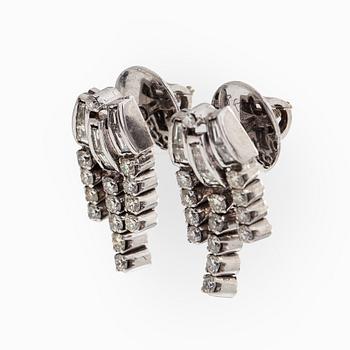 A pair of 18K white gold earrings set with baguette-cut and brilliant-cut diamonds.