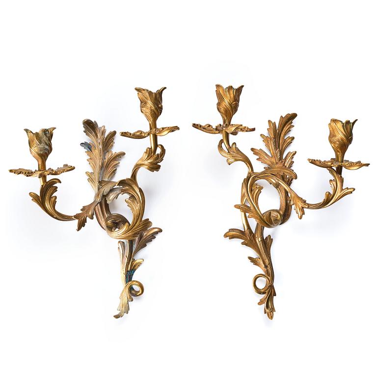 A pair of Rococo 18th century gilt bronze two light wall-lights.