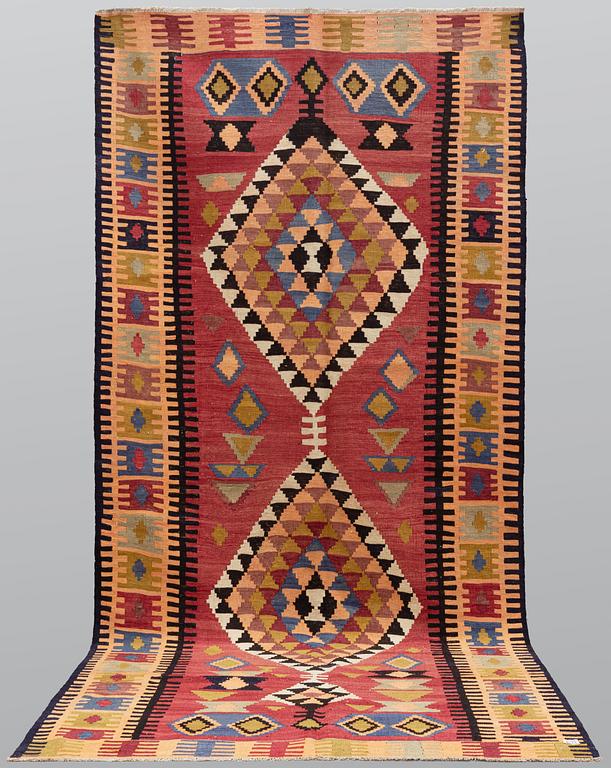 A Persian Nomad Kilim carpet, c 383 x 160 cm.