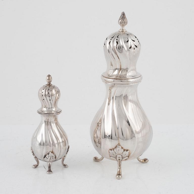 A silver sugarshaker and a peppershaker, Rococo style, 20th Century.