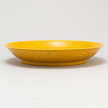 A Chinese yellow-glazed dish, 20th century.