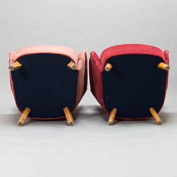 A pair of mid-20th-century armchairs.