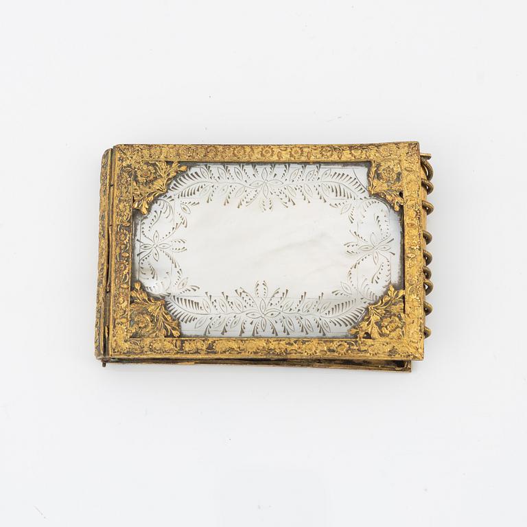 A gilt metal and mother-of-pearl pocket calendar, early 20th Century.