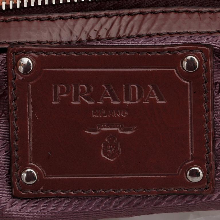 PRADA, a brown leather glace zipper bag.