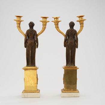 A pair of late Gustavian circa 1800 gilt and patinated bronze two-light candelabra.