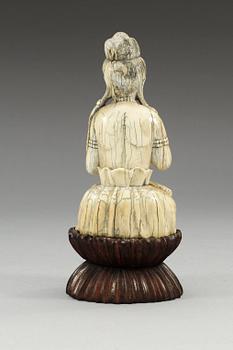 A carved ivory figure of a seated Guanyin, Qing dynasty or older.