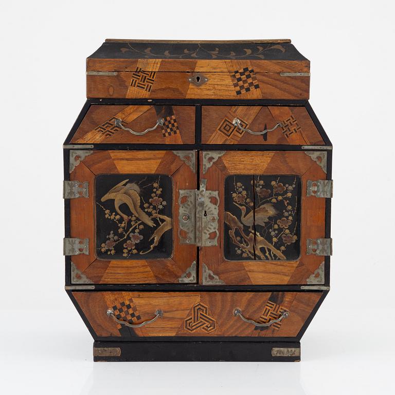 A Japenese partially lacquered hanging cabinet, early 20th century.