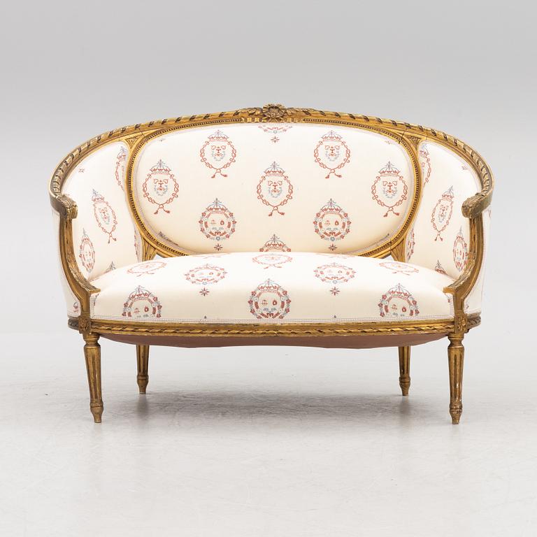 A Gustavian style sofa with two armchairs and two chairs, 20th century.