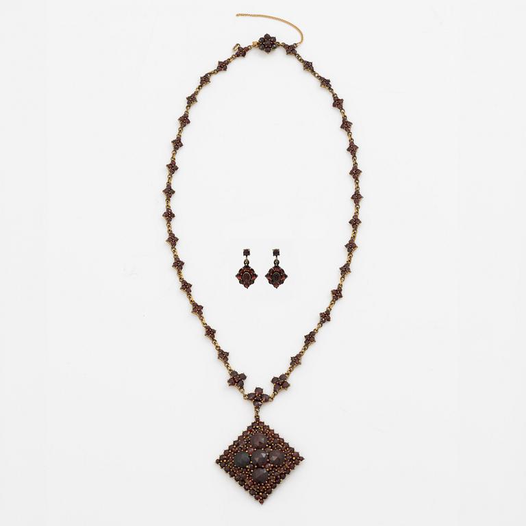 Pendant and a pair of earrings, gilt metal with garnets.