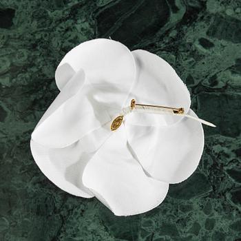 Camelia brooch by Chanel.