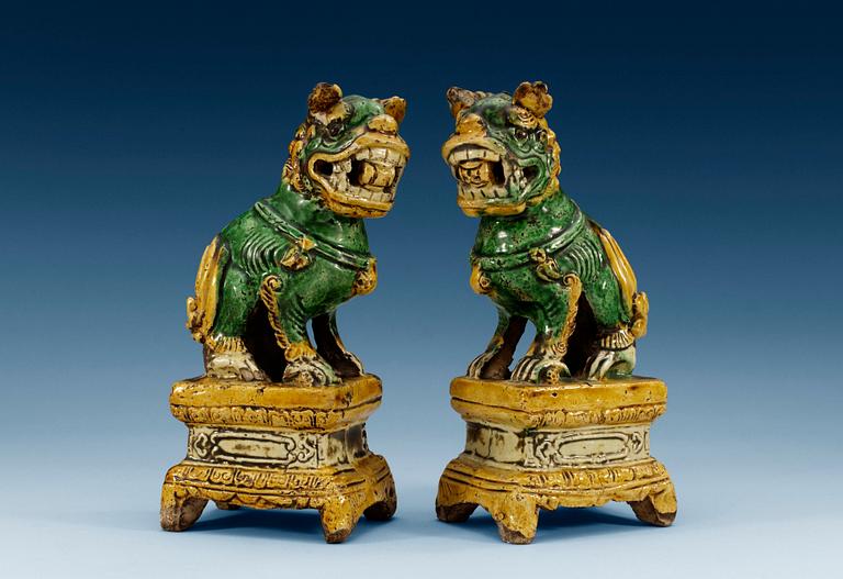 A pair of green and yellow glazed dogs, late Ming dynasty (1368-1644). (2).