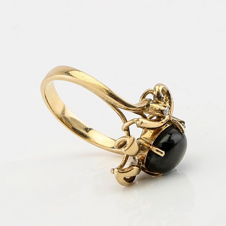 Ring and earrings in 14K gold with round brilliant-cut diamonds and likely natural black star sapphires.