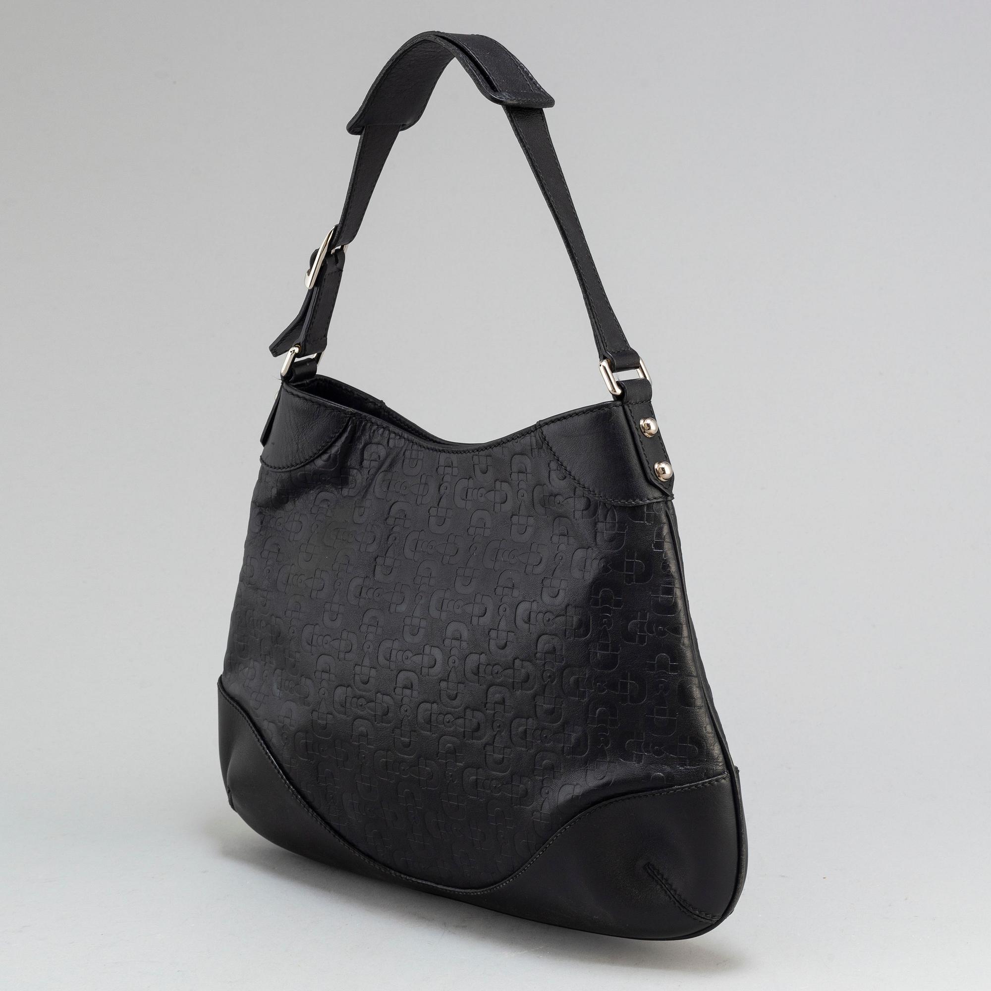 GUCCI, a black leather handbag.