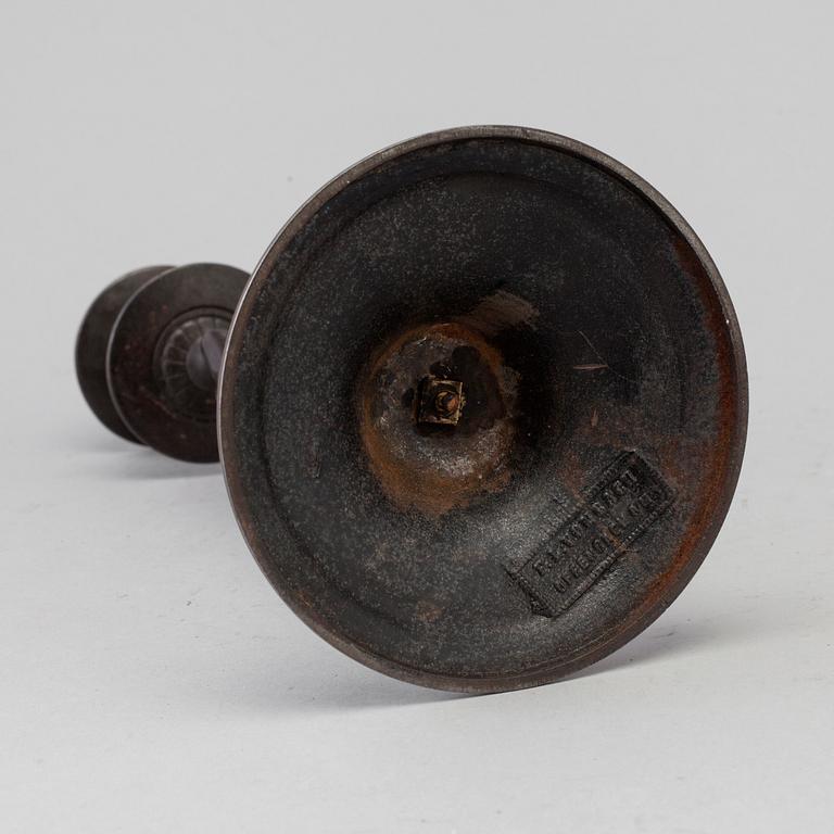A 19th century iron candlestick marked F.L Vombach Offenbach A/M.