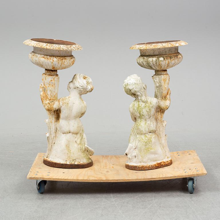 An end of the 20th Century pair of cast iron flower pots.