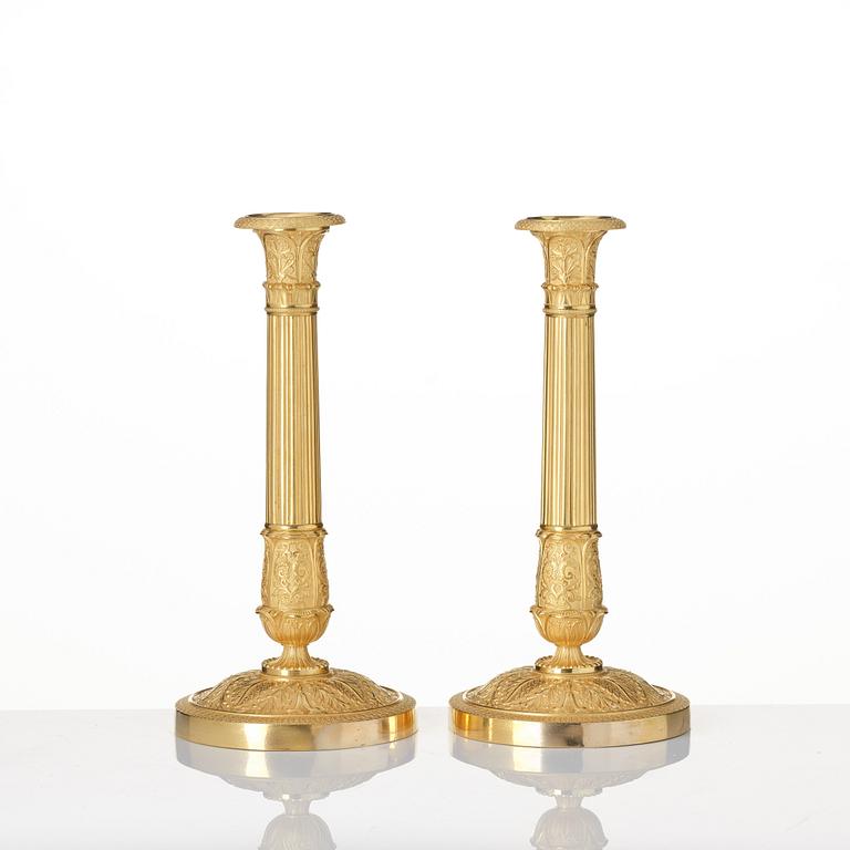 A pair of French Empire ormolu candlesticks, Paris, early 19th century.