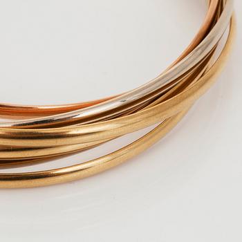 A Cartier "Trinity" bangle with 7 rings.