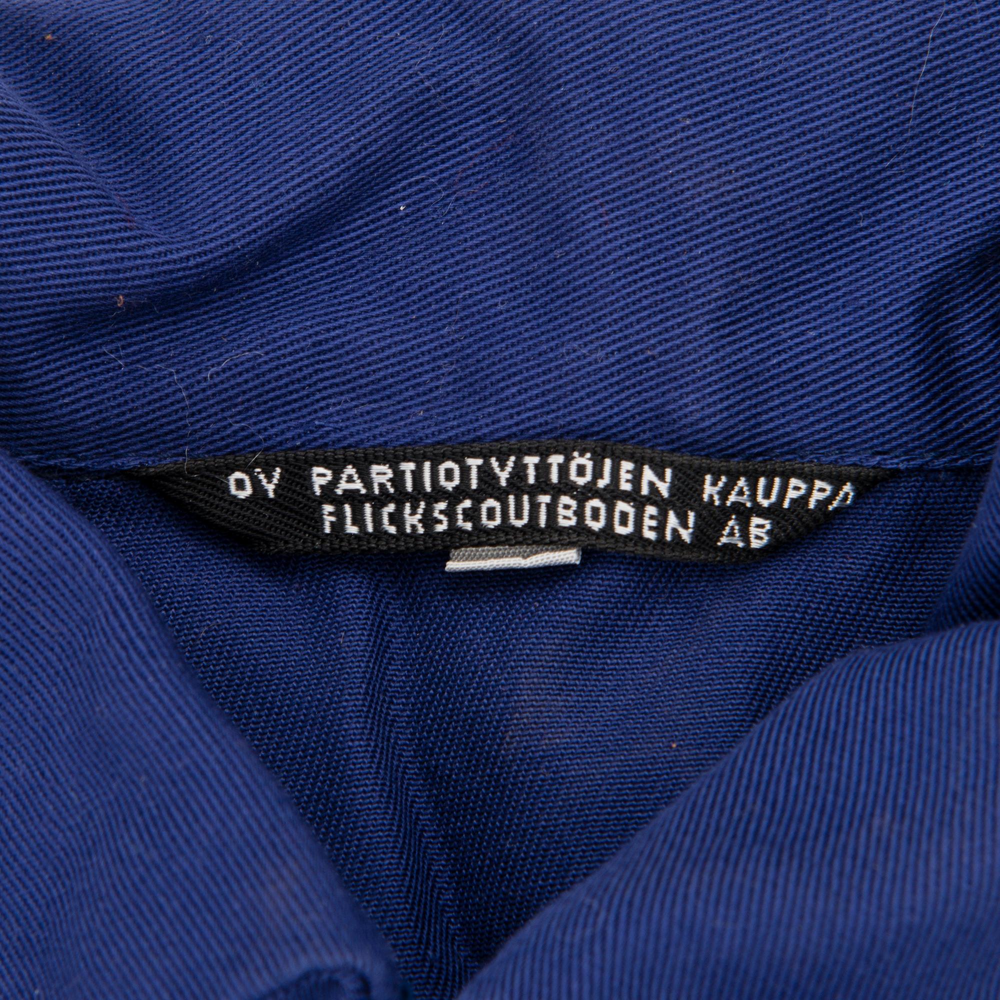 Two Finnish girl scouts uniforms with accessories and a boardgame, mid-second half of 20th Century.