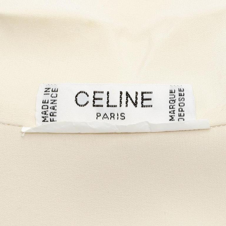 CÉLINE, a créme colored silk blouse.