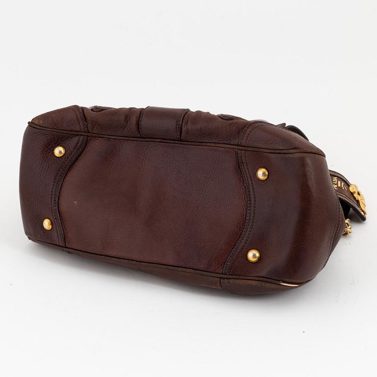 Prada, a brown leather bag.