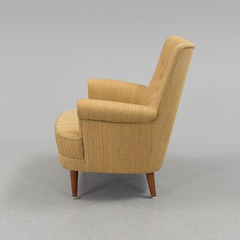 A mid 20th century armchair "Hemmakväll" designed by Carl Malmsten .