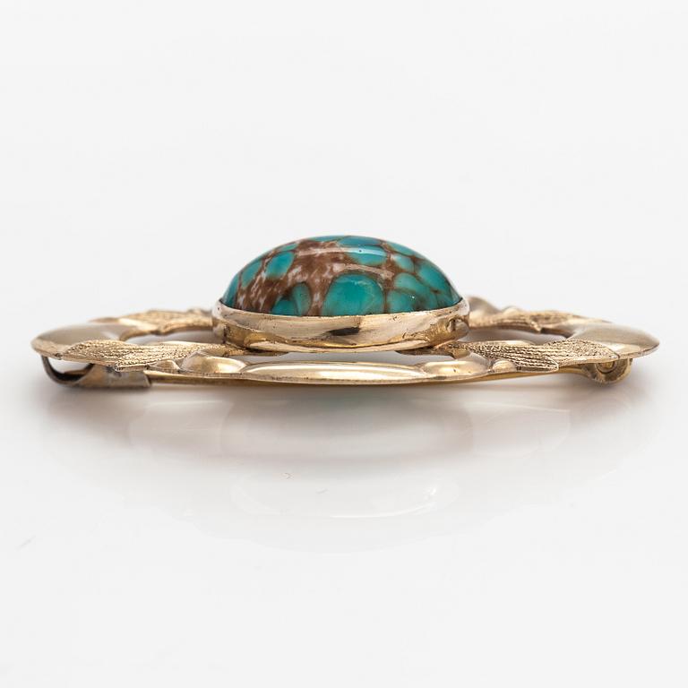 Elis Kauppi, A gilded silver brooch with a glass stone. Kupittaan kulta, Turku, 1940's.