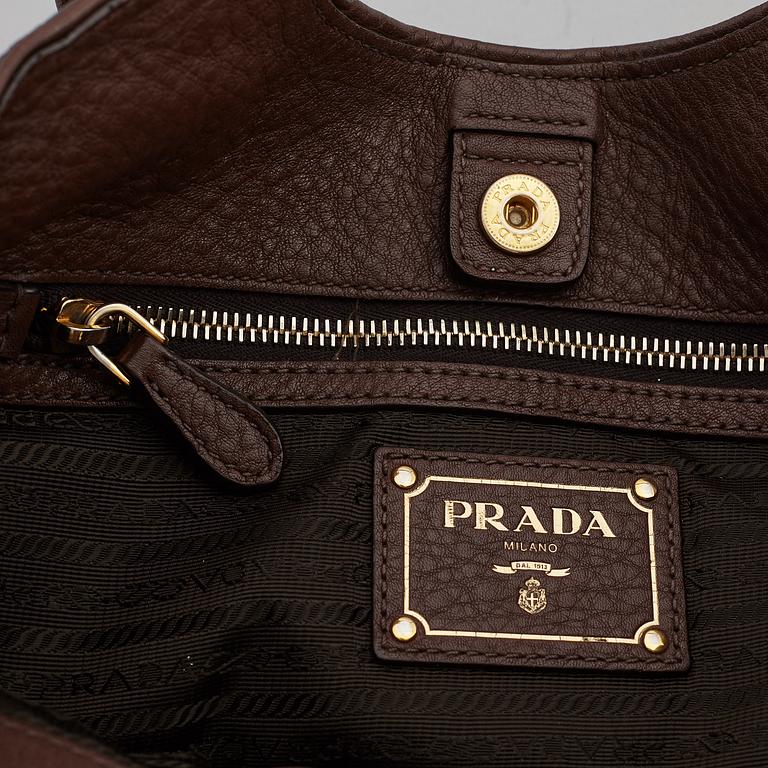 PRADA, a brown leather bag.